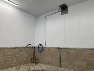Wash boom and hose connection point installed in the pallet washing area at a logistics facility in Ellistown.